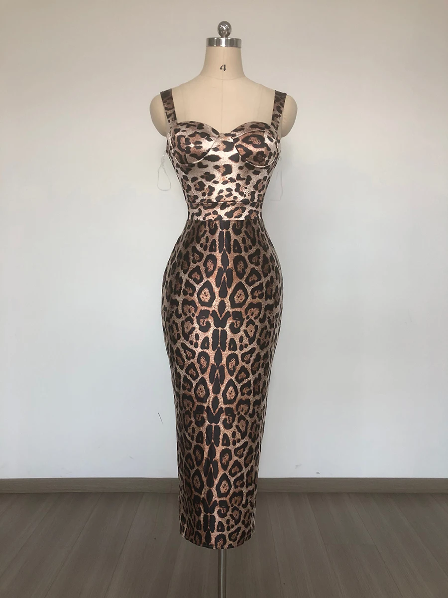 Woman wearing leopard print bodycon midi dress with bustier neckline and wide straps.