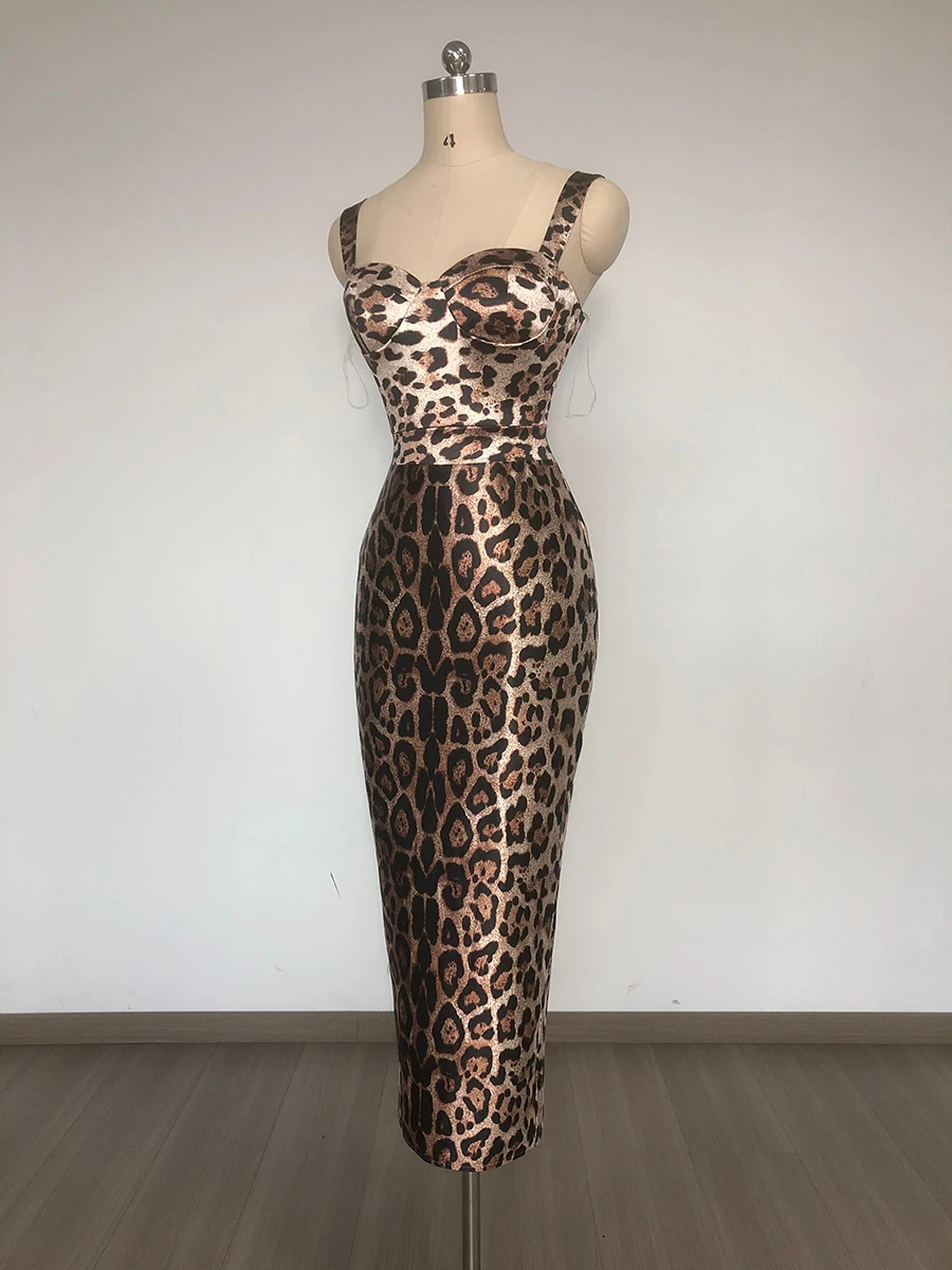 Woman wearing leopard print bodycon midi dress with bustier neckline and wide straps.